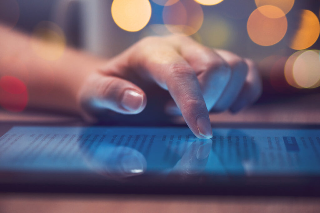 Photo of a woman reading online news on digital tablet