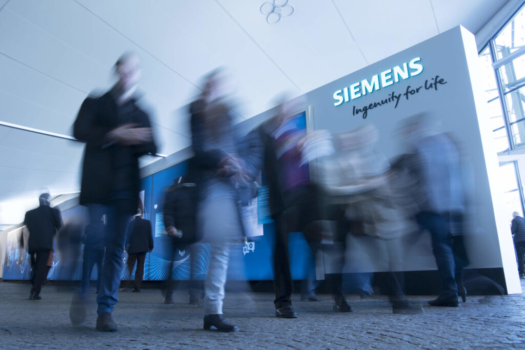 Fast-paced crowd outside a Siemens building