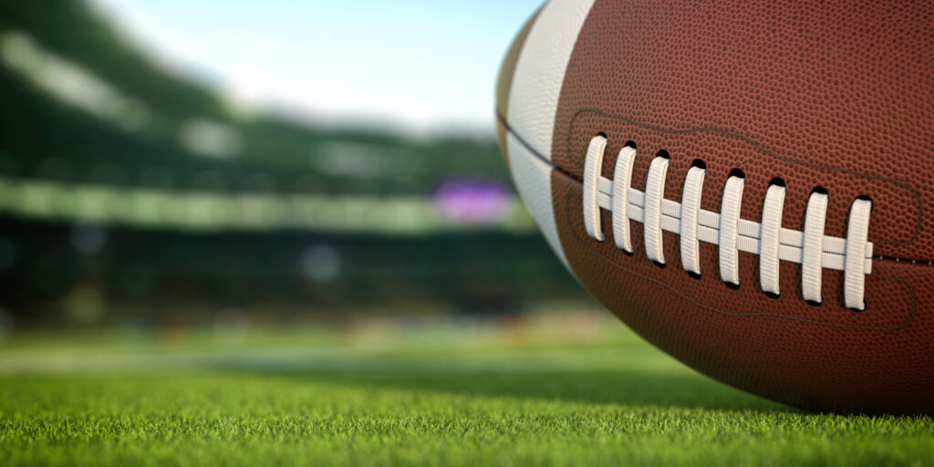 Photo of a striped football on turf