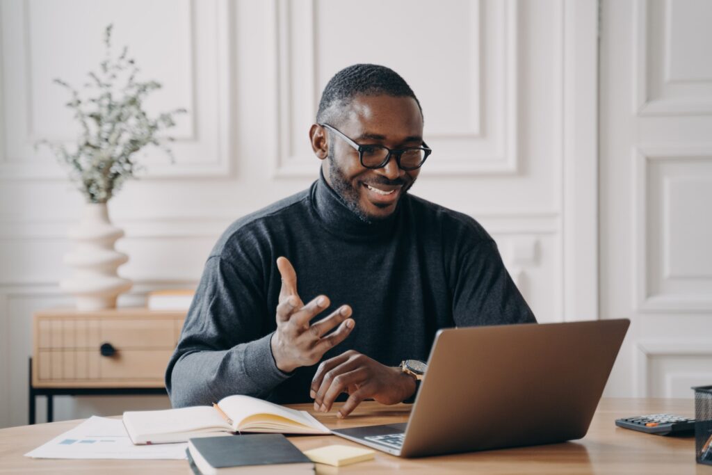 african-american-young-businessman-in-glasses-having-conference-online-with-employes-via-video-call_t20_wkPVg7
