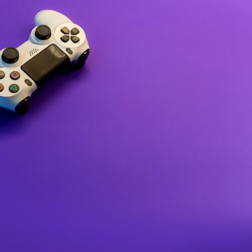 purple background with white Play Station controller in upper left hand corner.