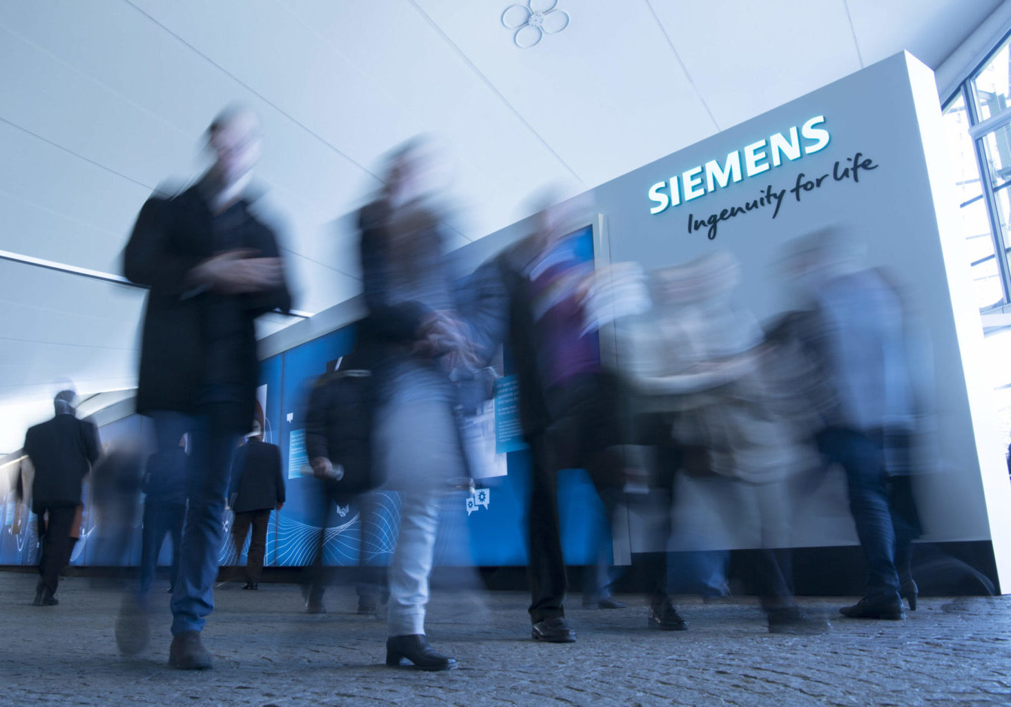Fast-paced crowd outside a Siemens building